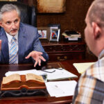 Current image: San Diego car insurance lawyer reviewing accident claim documents