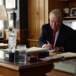 Current image: Client signing auto insurance settlement papers in San Francisco law office