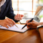 Current image: Photo of legal team consulting on National General Insurance customer service Texas bad faith claim