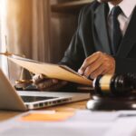 Current image: Business owner signing intellectual property insurance paperwork in Orlando.